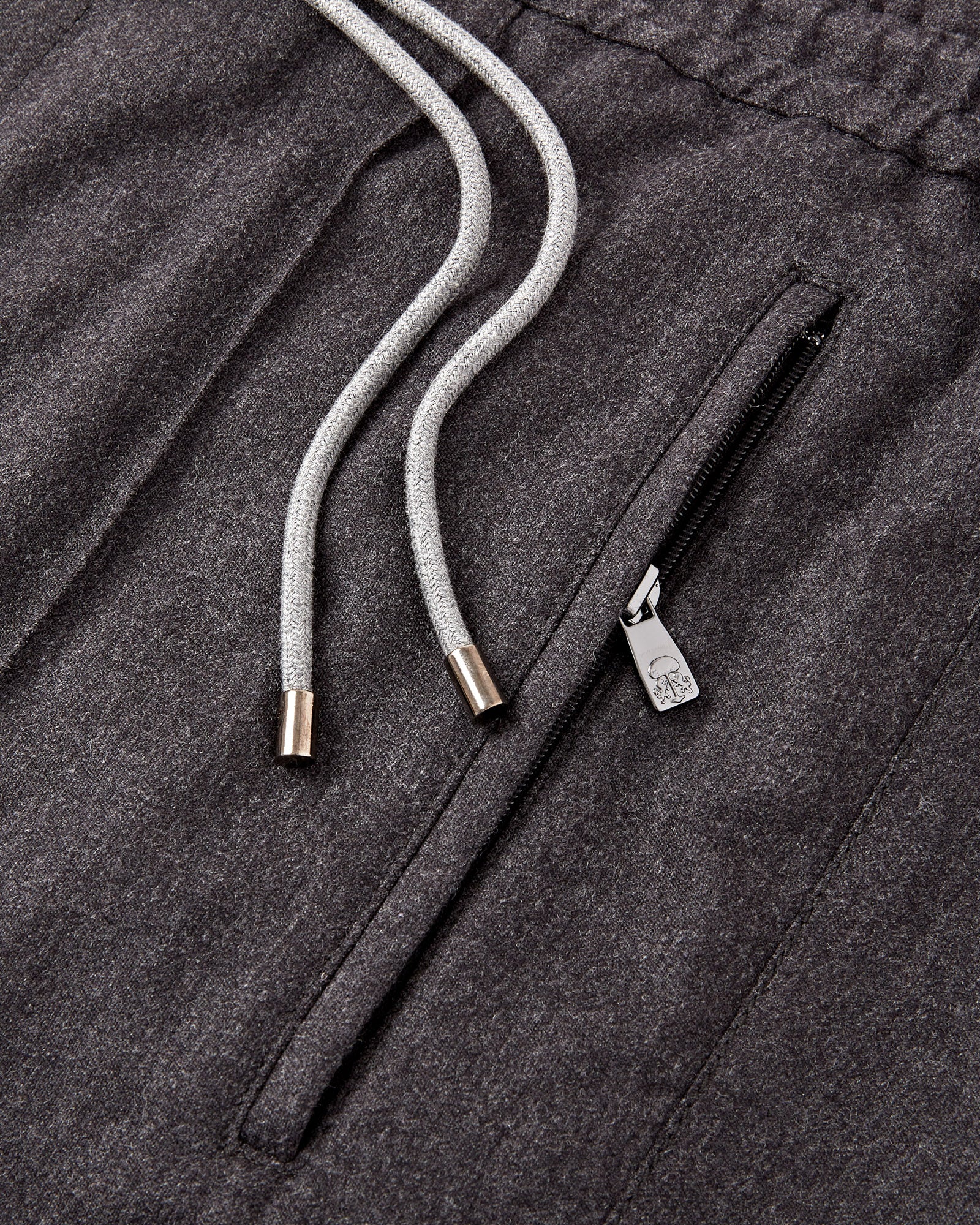 Grey flannel stretch pants detail: zipper pocket with drawstring cords