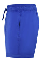 Cobalt blue swim shorts with elastic waist and drawstring, visible center seam