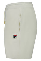 Pin tuck shorts in pale gardenia with logo patch on left leg and slanted front pocket