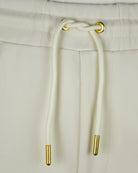 Elastic waistband and drawstring of pale gardenia pin tuck shorts with gold tips