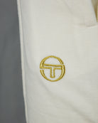 Gold circular logo embroidery on cream velour shorts
