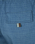 Blue micro-print swimshorts showing tan brand patch on back pocket