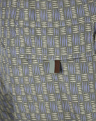 Swimshort fabric close-up with grey, lilac, and beige tribal stripe blocks