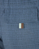 Navy micro-print swim shorts close-up of back pocket with stitched flap and tag