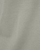 Natural beige knit T-shirt fabric close-up with fine texture