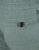 Canali micro-print swimshorts fabric close-up, teal green, small logo patch