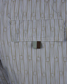 Patterned swim short fabric close-up with stitched hem and waistband panel