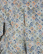 Paul & Shark swim shorts close-up, vertical seam detail on blue-beige diamond geometric print