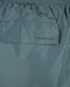 Corneliani logo label on green swim shorts, elastic waistband