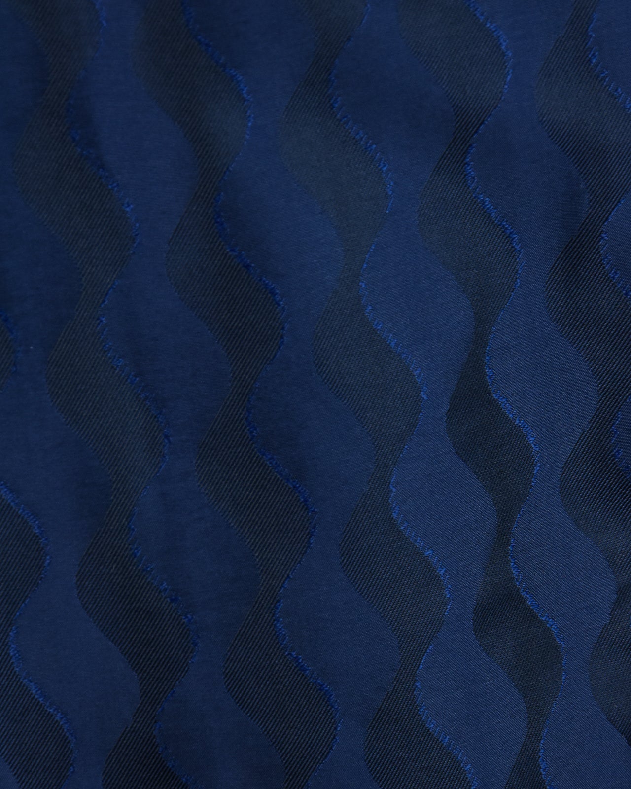 Navy jacquard fabric with repeating zigzag chevron pattern