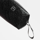 Waterproof wash bag in dark fabric with white logo mark and attached wrist strap