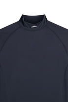 Navy mock-neck compression top neckline with small logo tab