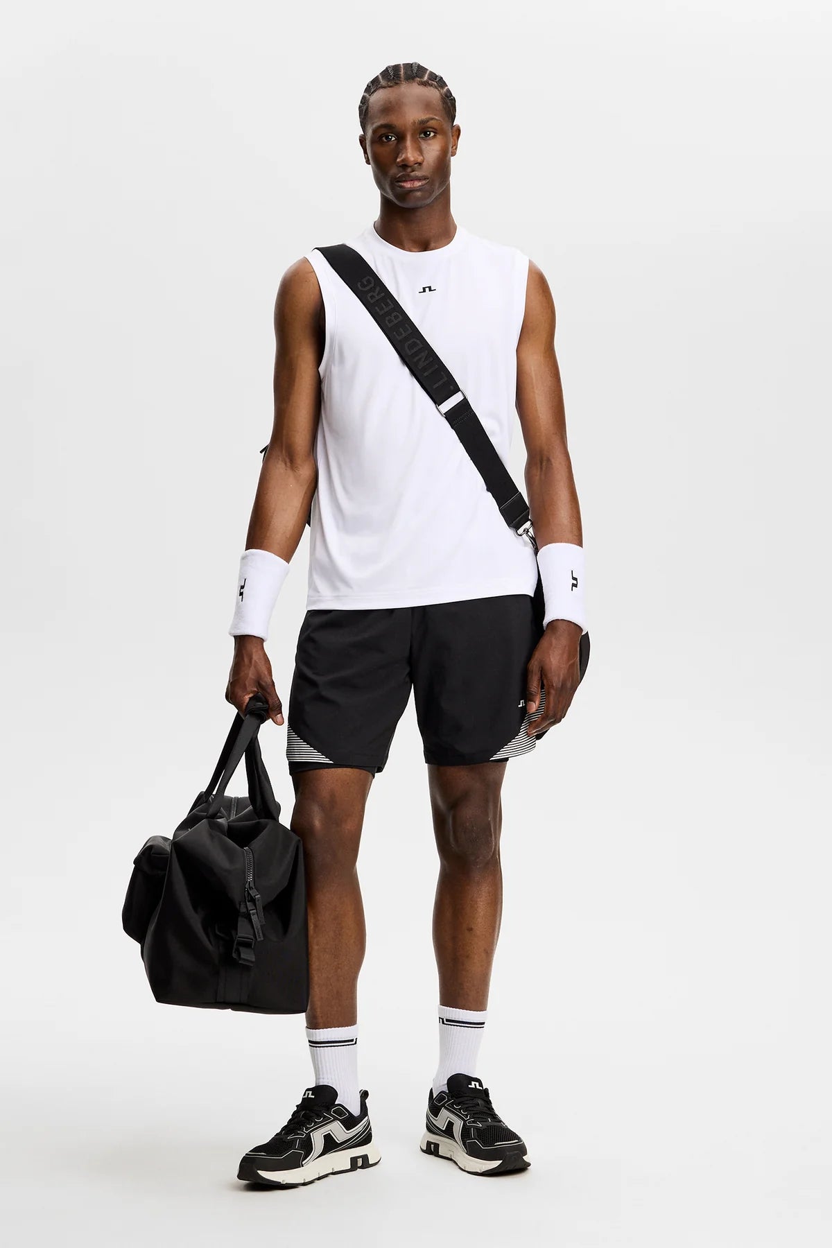 Black athletic shorts with elastic waistband and diagonal striped side insert