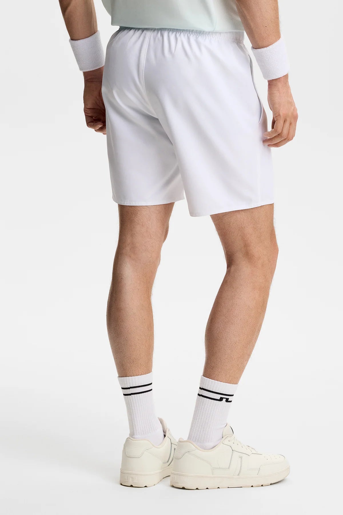 White pull-on shorts, side view with elastic waistband and straight hem.