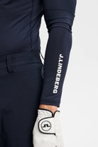 Navy sleeve cuff with vertical logo print on long-sleeve compression top