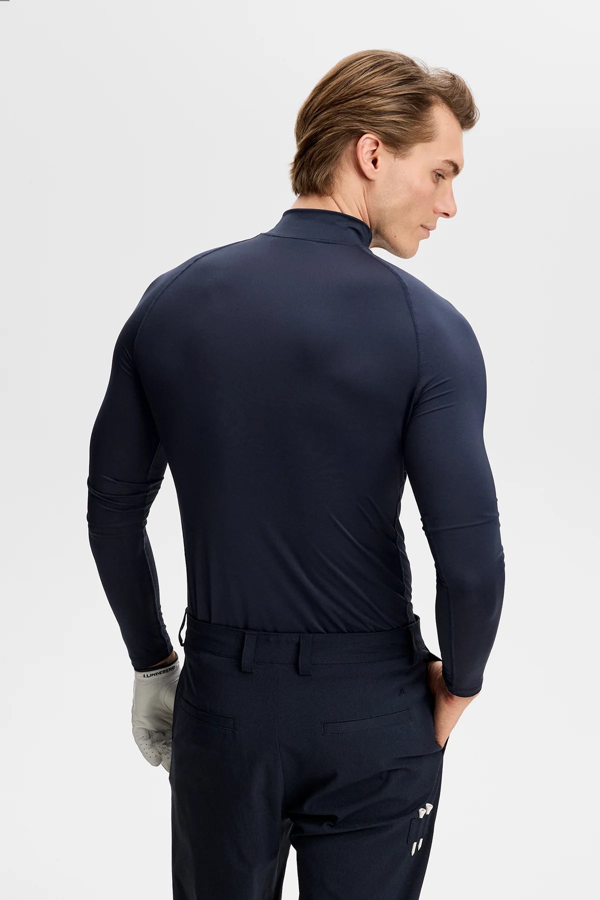 Navy mock-neck compression top, long sleeves, back view with logo detail