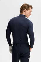 Navy mock-neck compression top, long sleeves, back view with logo detail