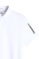 White J.Lindeberg Tour Tech polo close-up, J.Lindeberg chest and sleeve logo