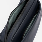 Interior view of midnight blue waterproof crossbody bag with dual zip pockets