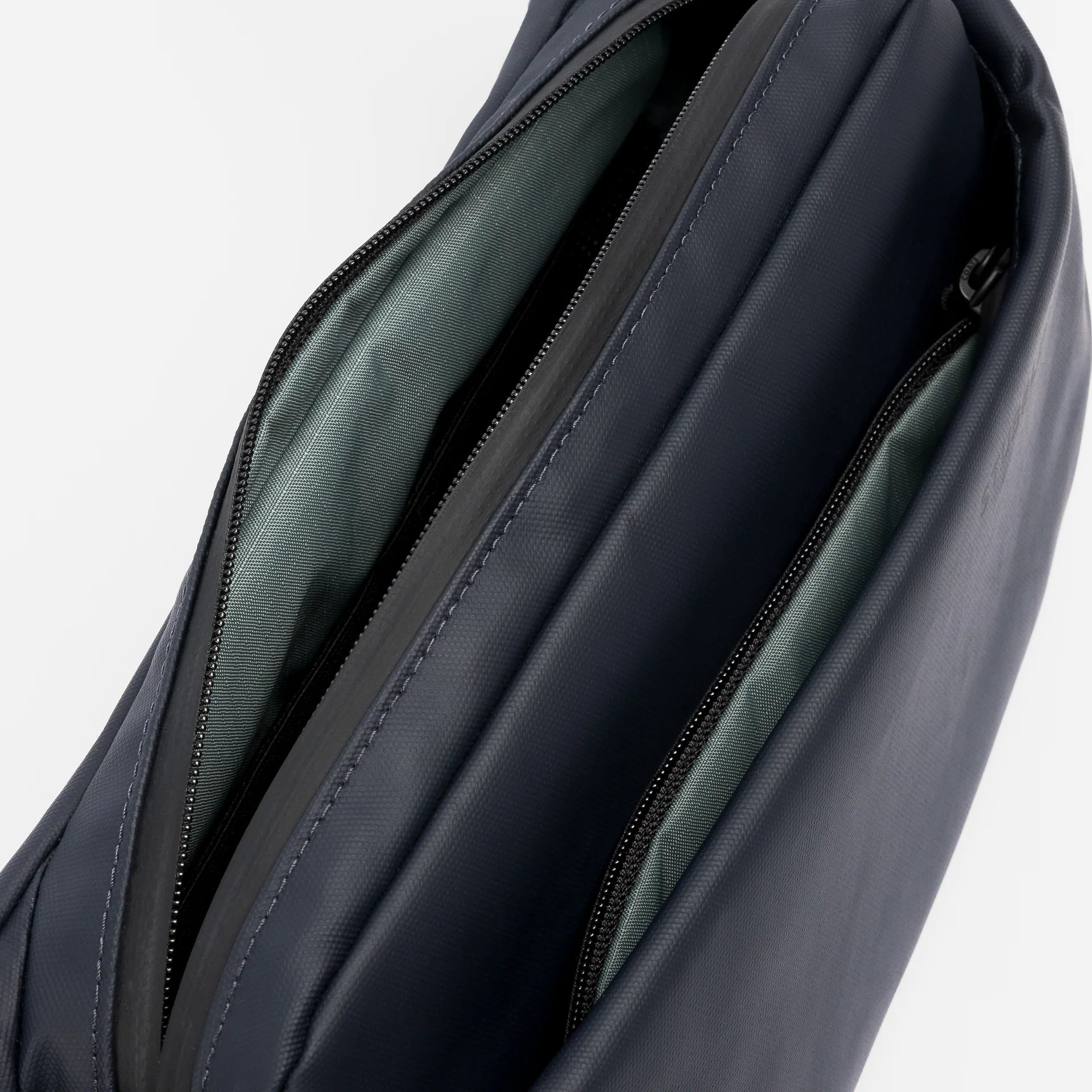 Interior view of midnight blue waterproof crossbody bag with dual zip pockets
