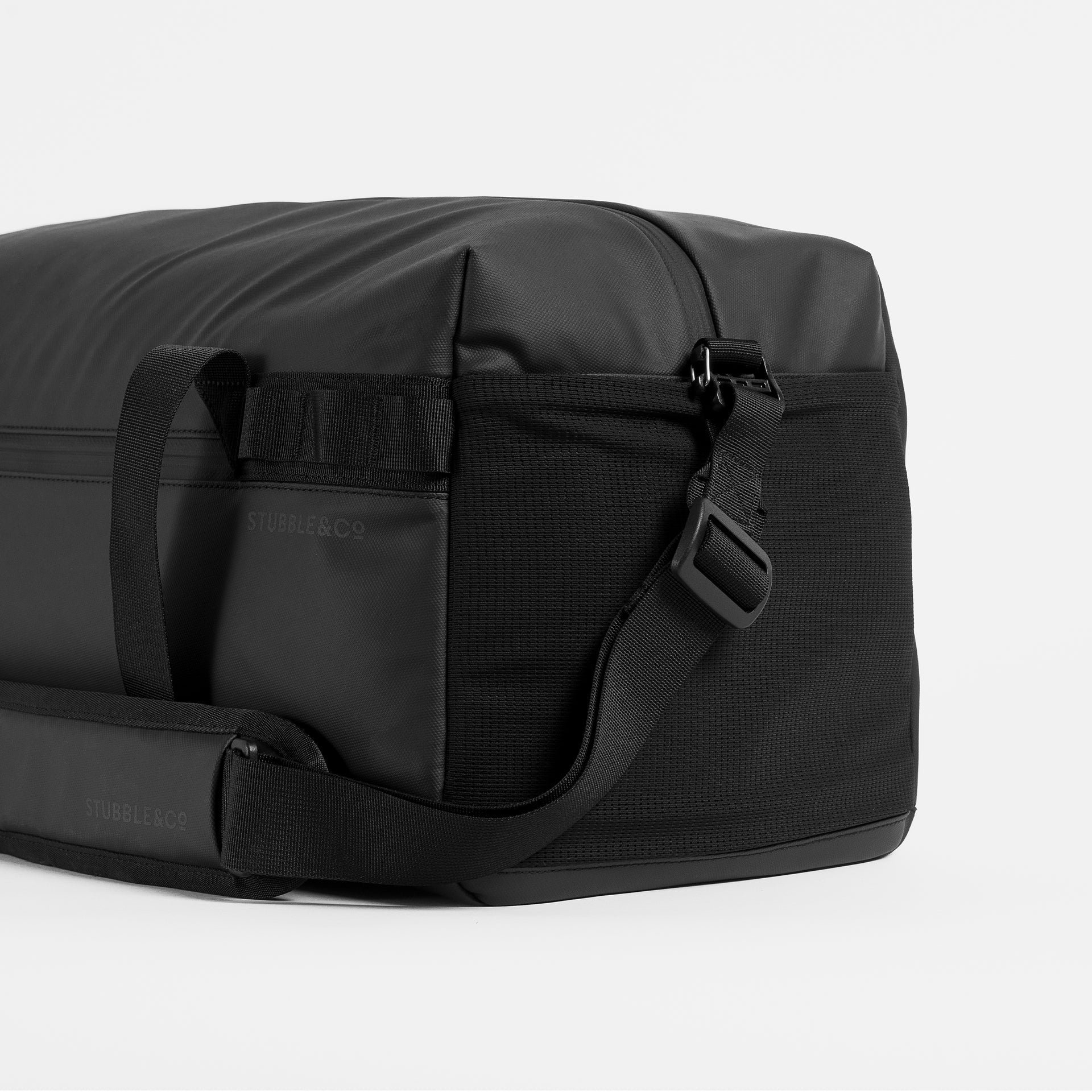 Stubble & Co gym duffel bag with side pocket and webbing strap detail, black