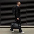 Stubble & Co gym duffel bag carried over shoulder with adjustable strap, black