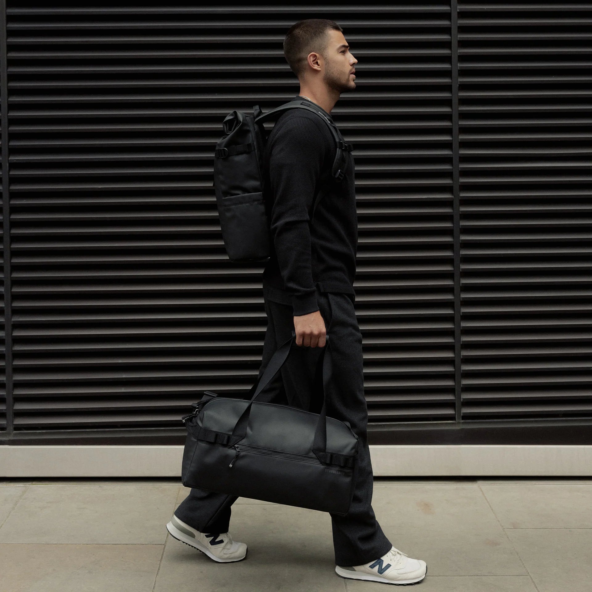 Stubble & Co gym duffel bag carried over shoulder with adjustable strap, black