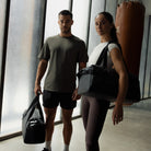 Stubble & Co gym duffel bag carried with shoulder strap, black