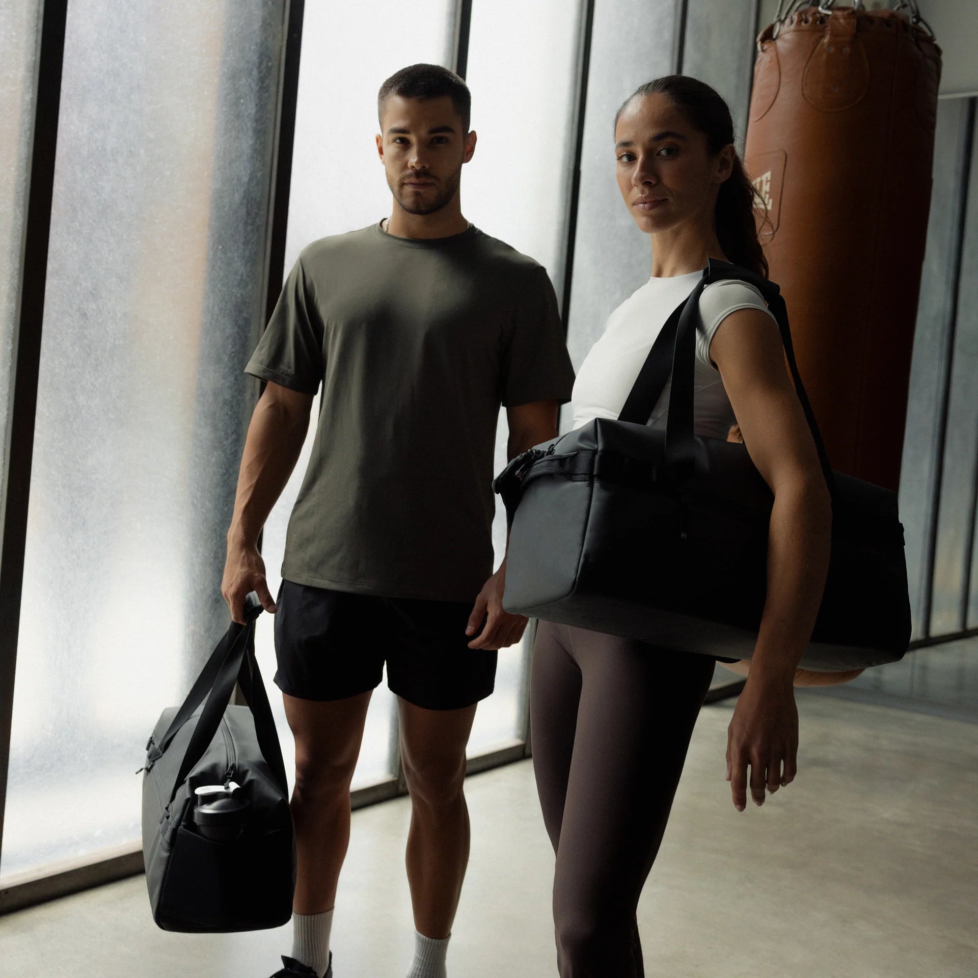 Stubble & Co gym duffel bag carried with shoulder strap, black