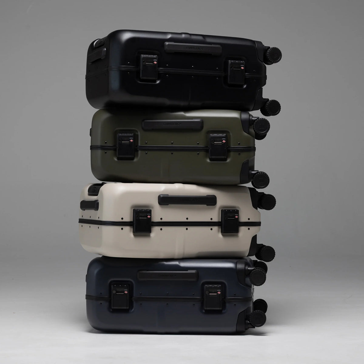 Color lineup of hardshell suitcases with corner locks and spinner wheels