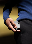 Secrid Miniwallet matte satin steel held in hand, front panel and push button