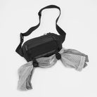 Charcoal crossbody sling bag laid flat with adjustable strap and front zipper