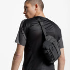 Charcoal crossbody sling bag shown from the back on a person