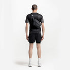 Charcoal sling bag worn across the back with adjustable shoulder strap