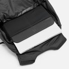 Dark gray padded laptop sleeve with zip closure inside the backpack main compartment
