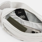 Gray waist waste pack interior with zippered pockets holding small items