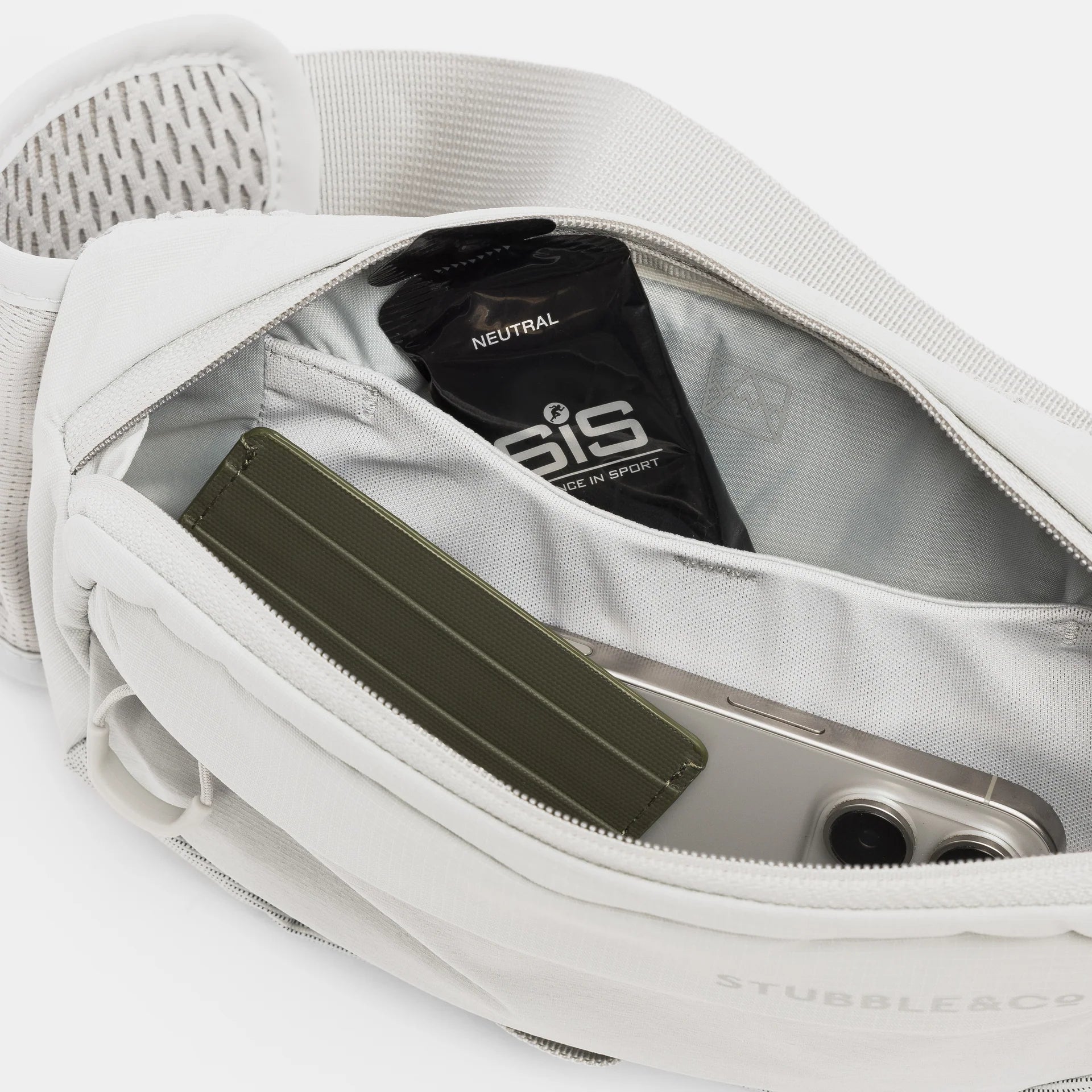 Gray waist waste pack interior with zippered pockets holding small items