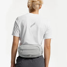 Gray waist waste pack worn at the waist, rear view with logo tab
