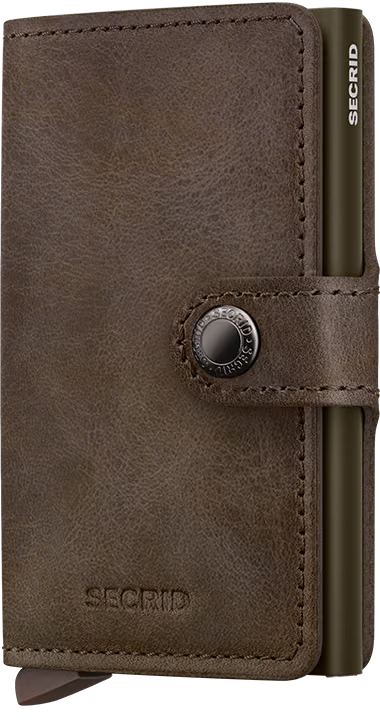 Secrid mini wallet in dark brown leather with stitched fold and snap button detail.