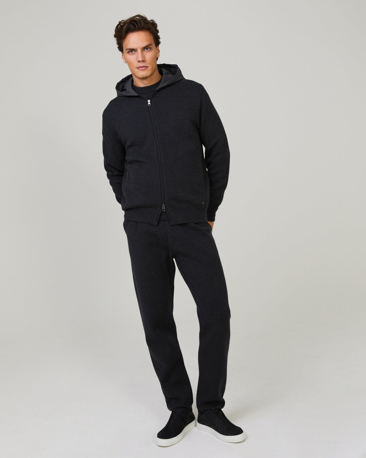 Model wearing night blue full-zip hoodie with hood and front zipper