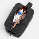 Waterproof wash bag with zip open, showing toiletries inside and grab strap